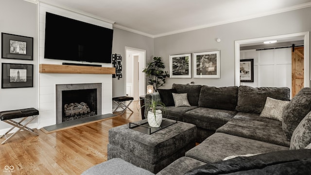 654 E 79th St, Indianapolis, IN 46240 - living room with wood finished floors, crown molding, a barn door, and a fireplace