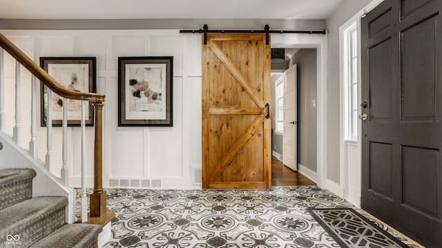 654 E 79th St, Indianapolis, IN 46240 - foyer featuring stairway, a barn door, and baseboards