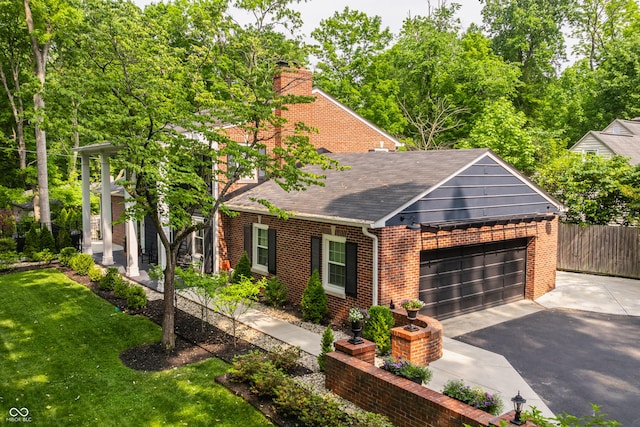 654 E 79th St, Indianapolis, IN 46240 - view of front facade with a shingled roof, a chimney, brick siding, asphalt driveway, and an attached garage
