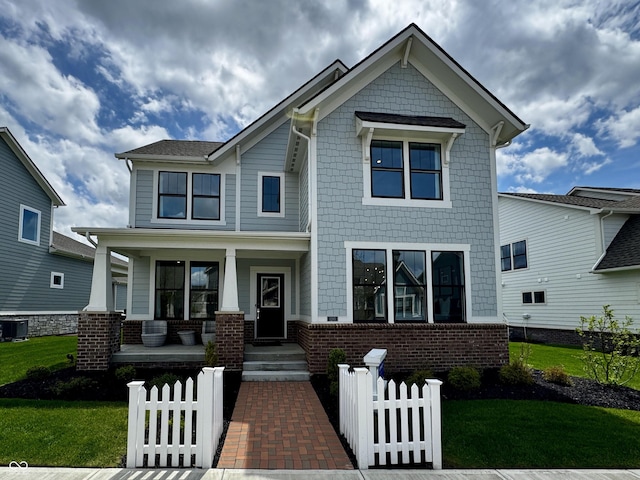 craftsman house featuring a porch, a front lawn, and fence