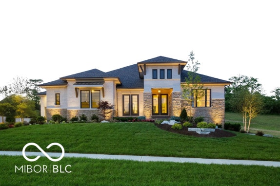 exterior space featuring stone siding and a yard
