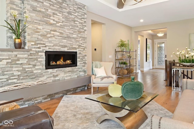 living room with a fireplace, recessed lighting, and wood finished floors