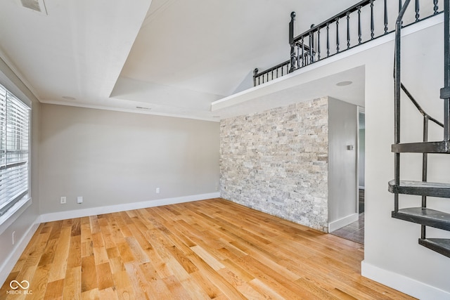 unfurnished room featuring ornamental molding, visible vents, wood finished floors, and baseboards