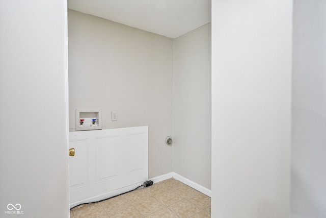 washroom featuring washer hookup, light tile patterned floors, laundry area, and baseboards