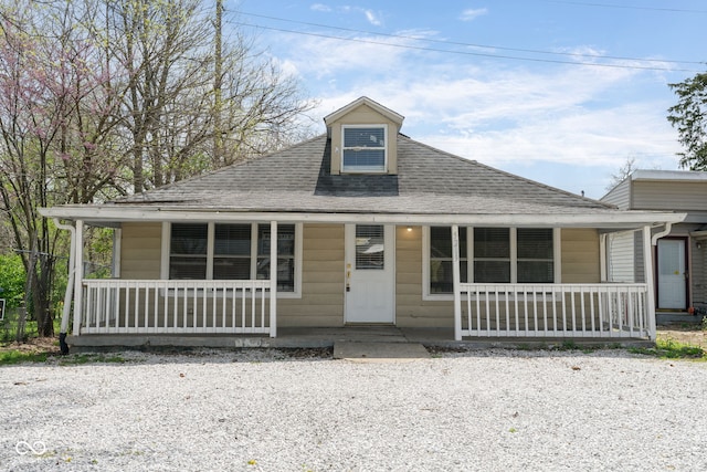 view of front of property featuring a porch and a shingled roof