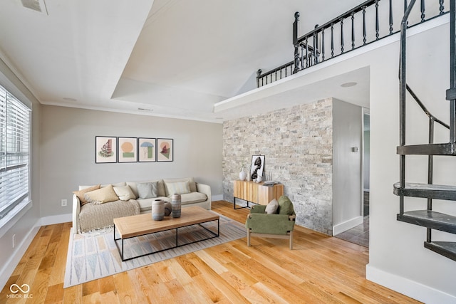 living room with baseboards, visible vents, and wood finished floors