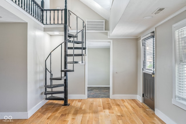 entrance foyer with baseboards, stairway, wood finished floors, and visible vents