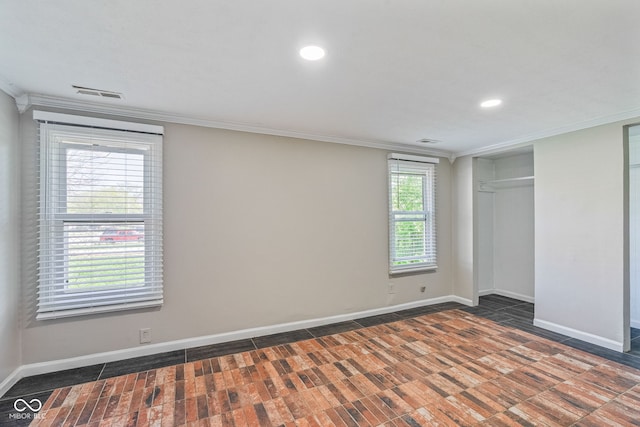 unfurnished bedroom featuring baseboards, recessed lighting, visible vents, and crown molding