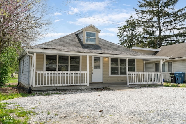view of front facade with a porch and roof with shingles