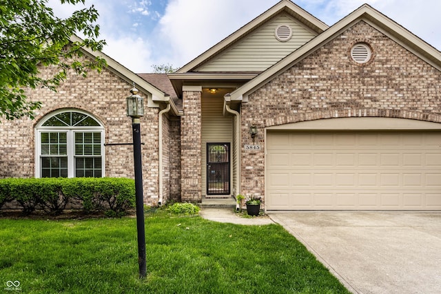 view of front of property with a front lawn, brick siding, a garage, and driveway