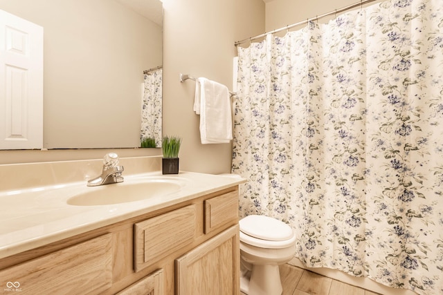 bathroom with toilet, vanity, wood finished floors, and a shower with shower curtain