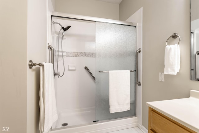bathroom featuring a shower stall and vanity