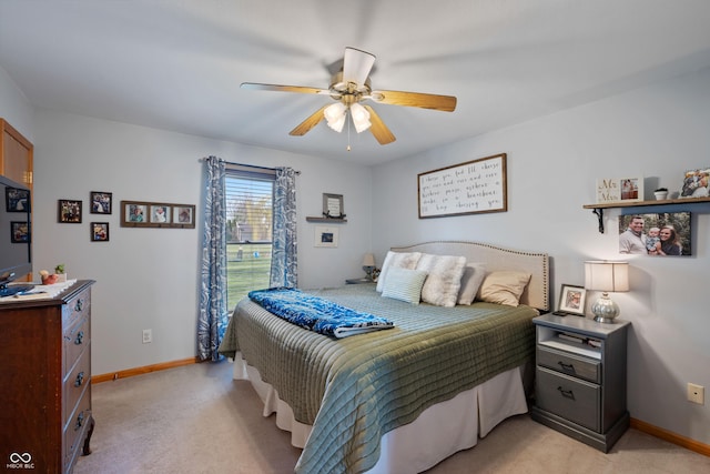 bedroom featuring baseboards, a ceiling fan, and light carpet