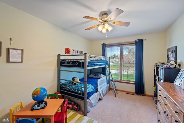 bedroom featuring a ceiling fan, baseboards, and light colored carpet