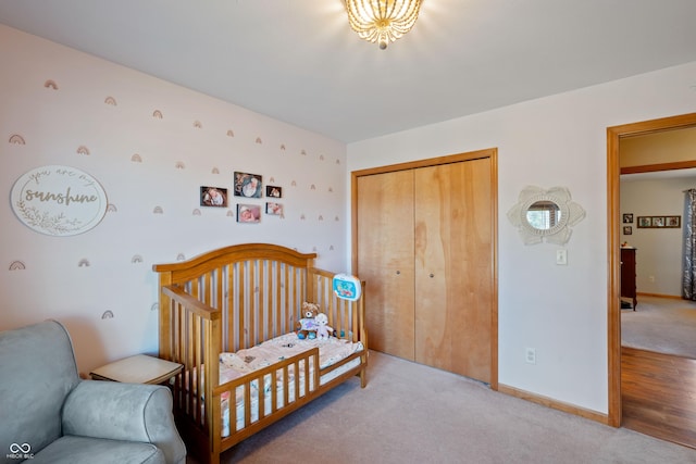 bedroom with baseboards, light carpet, and a closet