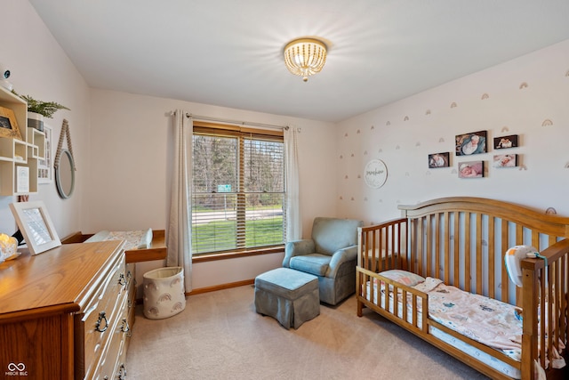 bedroom with baseboards and light carpet