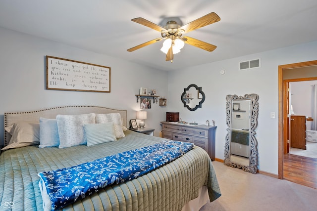 bedroom with light carpet, a ceiling fan, visible vents, and baseboards