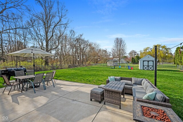 view of patio / terrace with a storage shed, an outbuilding, a fenced backyard, outdoor dining space, and an outdoor living space