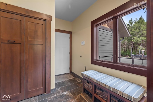 entrance foyer featuring stone tile floors and baseboards