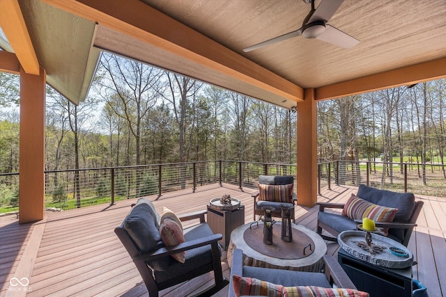 wooden deck with ceiling fan and outdoor lounge area