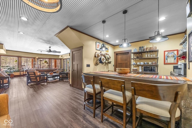 indoor dry bar with ceiling fan, dark wood finished floors, recessed lighting, and pendant lighting