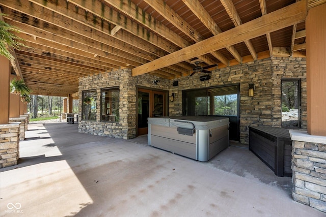 view of patio featuring a ceiling fan and a hot tub