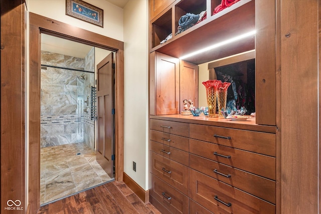 hallway with dark wood-type flooring and baseboards