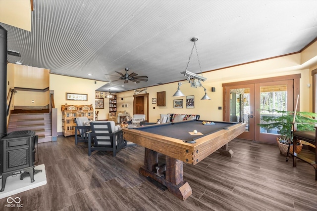 game room with french doors, a wood stove, billiards table, wood finished floors, and ceiling fan