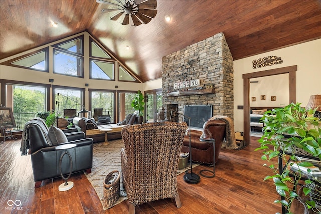 living area featuring a fireplace, hardwood / wood-style flooring, a ceiling fan, wooden ceiling, and high vaulted ceiling