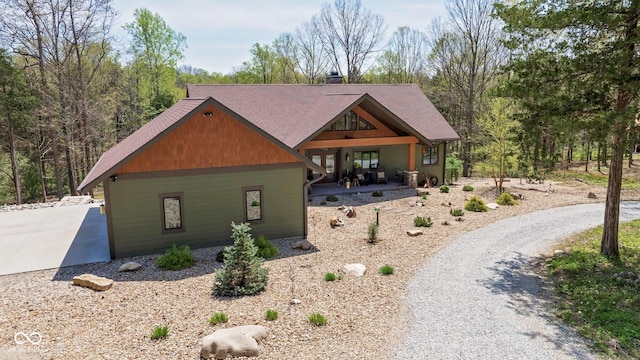 view of front of house with driveway and roof with shingles