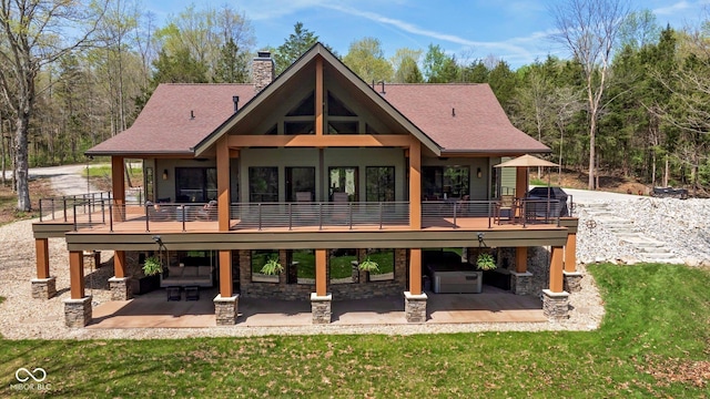 back of property featuring a patio, a yard, a chimney, and a deck