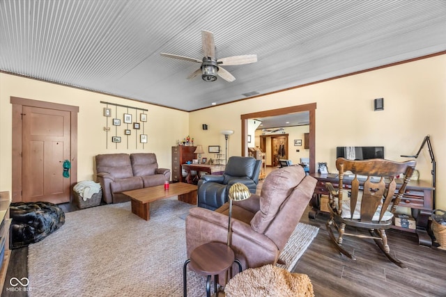 living room with ceiling fan, wood finished floors, and crown molding