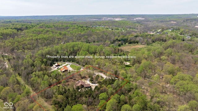 view of property location featuring a heavily wooded area and property parcel outlined