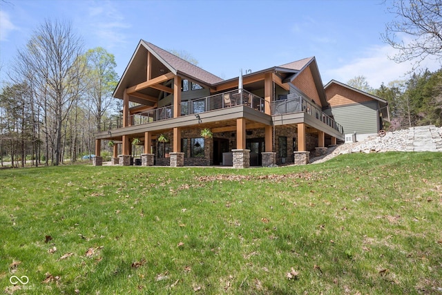 rear view of property featuring stone siding and a lawn