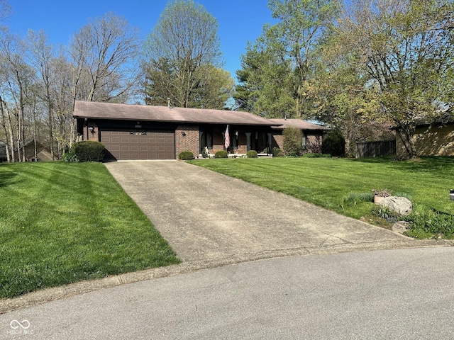 3920 Pigeon Creek Ln, Indianapolis, IN 46234 - ranch-style house with an attached garage, brick siding, a front yard, and concrete driveway
