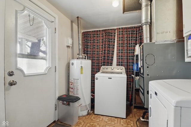 laundry room featuring light floors, washer and clothes dryer, gas water heater, and laundry area