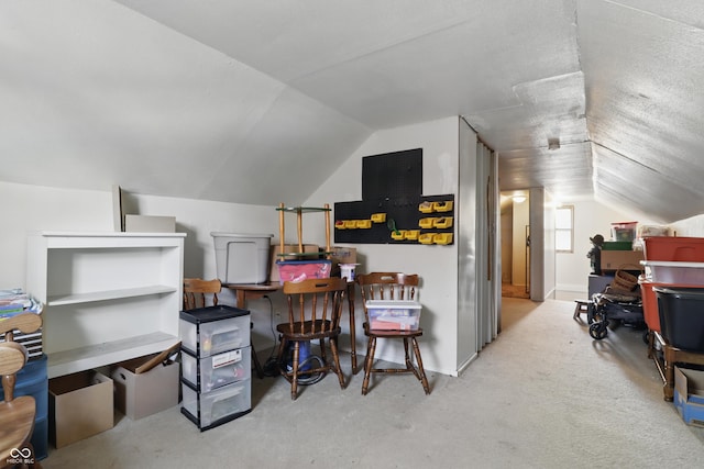 carpeted home office with lofted ceiling