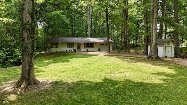 7550 N Lakewood Dr, Unionville, IN 47468 - view of front of property featuring a front yard, dirt driveway, a view of trees, and covered porch
