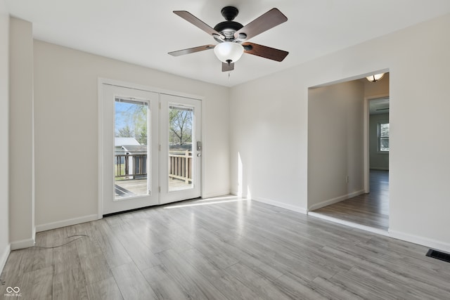 911 W Washington Ave, Shelbyville, IN 46176 - unfurnished room with a ceiling fan, visible vents, wood finished floors, and baseboards