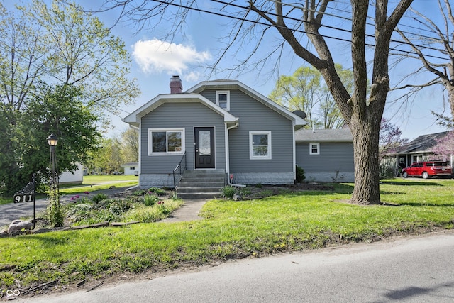 911 W Washington Ave, Shelbyville, IN 46176 - bungalow-style house featuring a chimney, entry steps, and a front lawn
