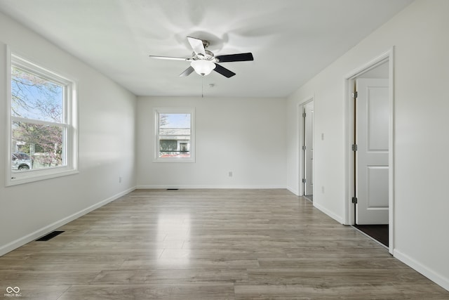 911 W Washington Ave, Shelbyville, IN 46176 - empty room featuring ceiling fan, baseboards, wood finished floors, and visible vents