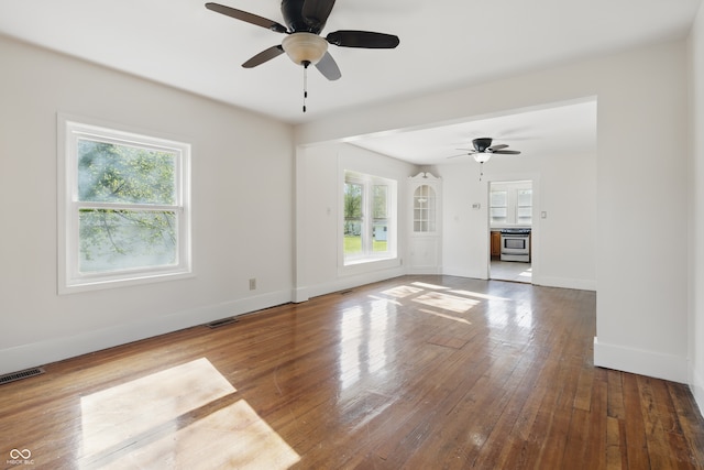 911 W Washington Ave, Shelbyville, IN 46176 - unfurnished living room with visible vents, ceiling fan, and a healthy amount of sunlight