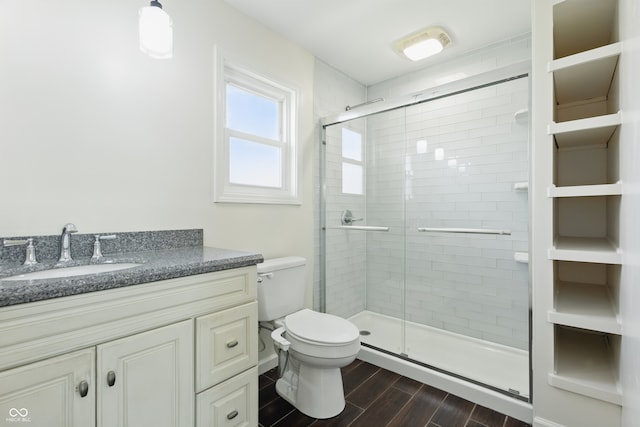 911 W Washington Ave, Shelbyville, IN 46176 - full bathroom featuring wood finished floors, toilet, a stall shower, and vanity