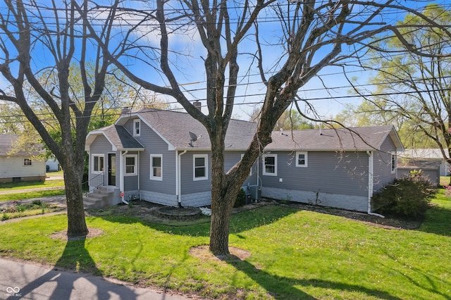 911 W Washington Ave, Shelbyville, IN 46176 - exterior space with a shingled roof, a front yard, and central air condition unit