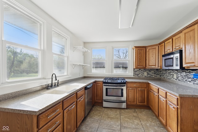 911 W Washington Ave, Shelbyville, IN 46176 - kitchen featuring open shelves, appliances with stainless steel finishes, brown cabinets, backsplash, and a sink