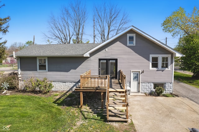 911 W Washington Ave, Shelbyville, IN 46176 - back of house featuring a wooden deck, a shingled roof, stairs, and a lawn