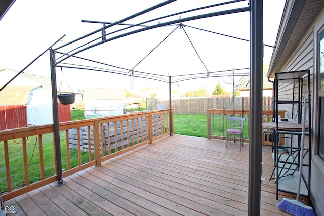 wooden deck featuring a fenced backyard and a yard