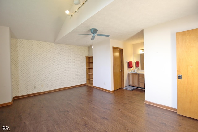 unfurnished room featuring wallpapered walls, baseboards, and dark wood-type flooring