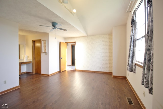 empty room featuring visible vents, baseboards, wood finished floors, and a wealth of natural light
