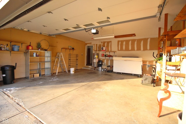 garage featuring water heater and a garage door opener